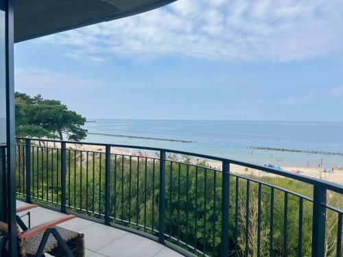 a balcony with a view of the beach at Porto Mare Apartamenty in Skorka