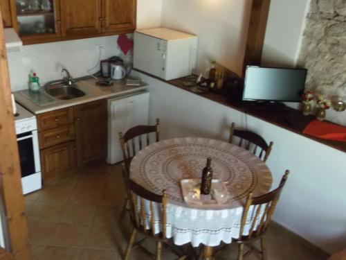a small kitchen with a table and a sink at Sivros Stone Cottages in Sívros
