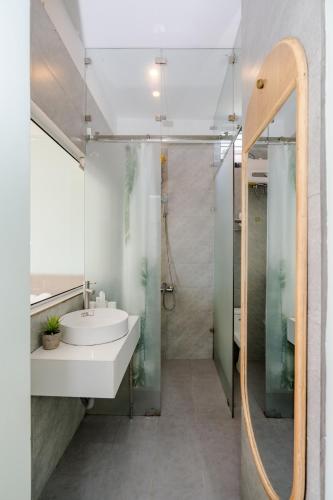 a bathroom with a sink and a shower at Aluna Residence Homestay in Da Nang