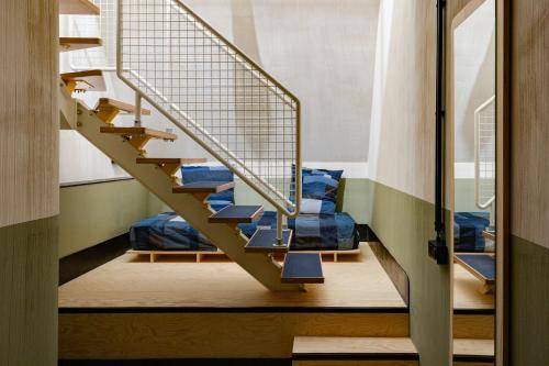 a staircase in a room with blue pillows at JAM Ghent in Ghent