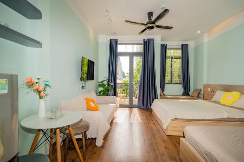 a living room with two beds and a table at Aluna Residence Homestay in Da Nang