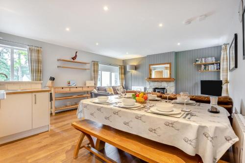 a kitchen and a living room with a table in a room at 3 Bed in Newtonmore oc-h32416 in Newtonmore