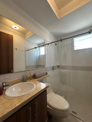 a bathroom with a toilet and a sink and a shower at Apartamento Ciudad Santa Bárbara con vista panorámica, cerca a Cali y aeropuerto in Palmira