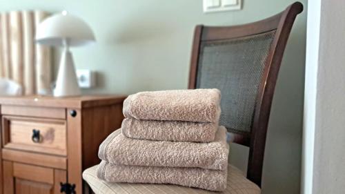 a stack of towels sitting on top of a chair at Casa Marsal - Proap Apartments in Encamp