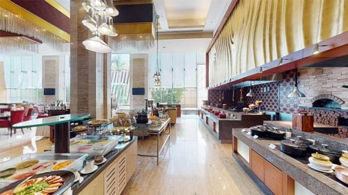 a large kitchen with a lot of food on display at Radisson Blu Hotel, Nagpur in Nagpur