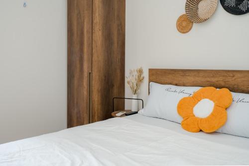 a stuffed orange teddy bear sitting on top of a bed at Aluna Residence Homestay in Da Nang