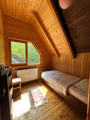 a bedroom with a bed and a window in a room at Hostel & Camping Rilindja in Valbonë