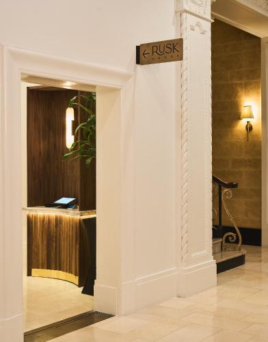 a room with a wall with a sign that reads trust at Rusk House Serviced Apartments in Houston