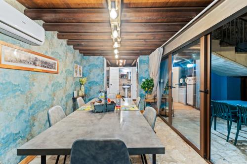 a dining room with a long table and chairs at RedBlue Door Two Traditional Listed Houses in Pano Lefkara