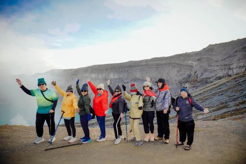 a group of people standing on top of a mountain at Pandan Arum Surfing in Pulau Lutung