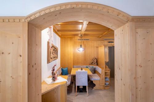 a wooden room with a table and a dining room at Garni Crepaz in Selva di Val Gardena