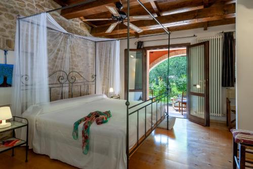 Un dormitorio con una cama grande con ventilador de techo. en Casale Belvedere 8&1 by Marche Holiday Villas, en Monteciccardo