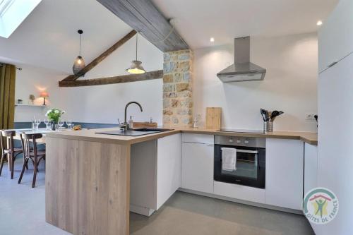 a kitchen with a sink and a counter top at Juliette in Saint-Georges-de-Chesné