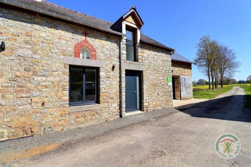 a stone house with a driveway in front of it at Juliette in Saint-Georges-de-Chesné