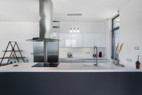 a kitchen with a sink and a stove at Villa Seaview Serenity - Jacuzzi & Panoramic Views in Chania