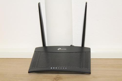 a black router sitting on top of a wooden floor at Argenta Center every comfort in Argenta