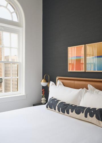 a bedroom with a white bed and a window at Rusk House Serviced Apartments in Houston