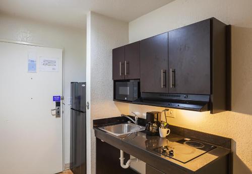 a kitchen with a sink and a microwave at Studio 6 Fort Worth, TX - Meacham in Fort Worth