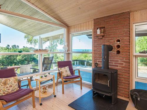 a living room with a fireplace and a stove at Lakeview Hideaway - By Traum Ferienwohnungen in Ørby