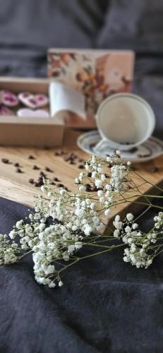 a bunch of white flowers on a wooden board at Apartament Przy Murach in Toruń
