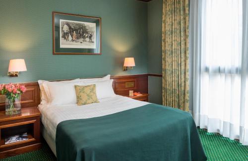 a hotel room with a bed and a window at Leonardo Hotel Milan City Center in Milan