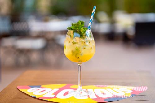 a drink in a glass on a napkin at Leonardo Hotel Milan City Center in Milan