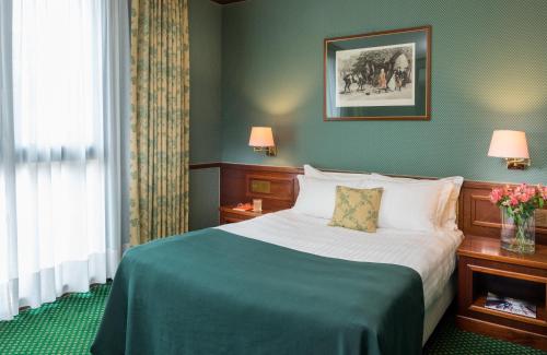 a hotel room with a bed and a window at Leonardo Hotel Milan City Center in Milan