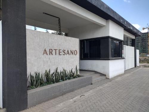 a building with the entrance to an art museum at Lenayan at Artesano in Nairobi