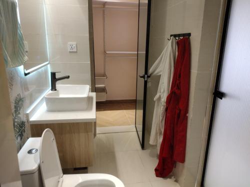 a bathroom with a toilet and a sink at Lenayan at Artesano in Nairobi