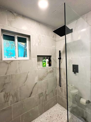 a bathroom with a shower with a glass door at 2BR Apt 4 mins to OCU Monthly 15 Off #19A in Oklahoma City