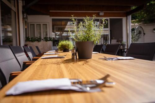 a long wooden table with a pair of glasses on it at Hotel Bessunger Forst in Roßdorf