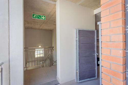 an empty room with a exit sign on the wall at Luxury Apartment - Apartment 44 - 1 On York in George