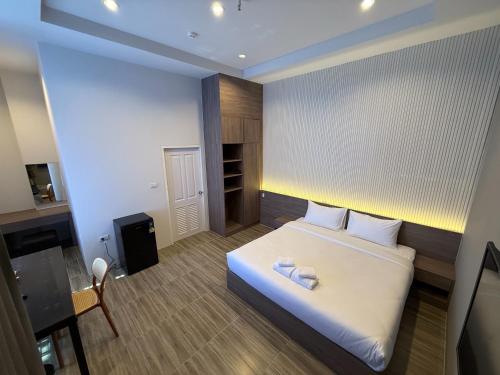 a bedroom with a bed with two towels on it at GrandWara Khao Yai แกรนด์วารา เขาใหญ่ in Ban Nong Song Hong