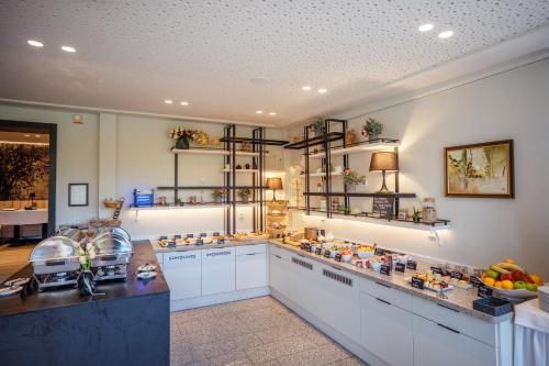 a kitchen with shelves and a counter with food at Hotel Bessunger Forst in Roßdorf