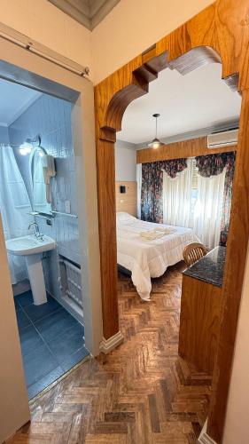 a bedroom with a bed and a bathroom with a sink at Diplomat Hotel in Buenos Aires