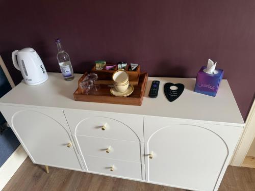 a white dresser with a bottle of soap and a box at The Salt house in Golspie