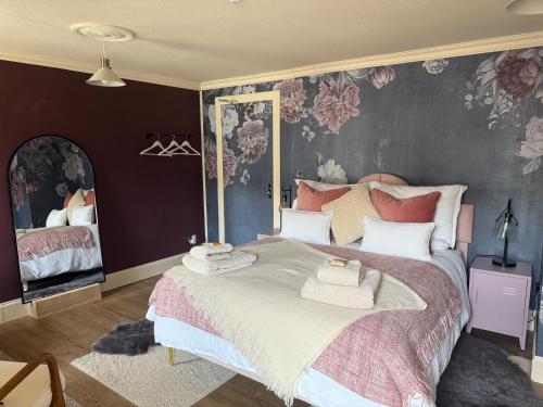 a bedroom with a large bed with towels on it at The Salt house in Golspie