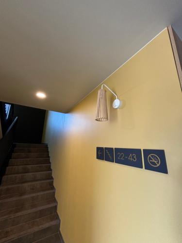 a staircase with a light and a sign on the wall at MDS Bonikowo in Bonikowo