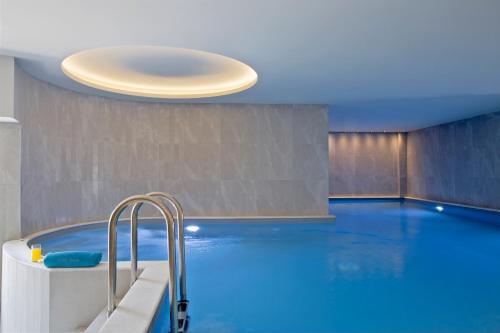 a large swimming pool with a light fixture above it at Eretria Hotel & Spa Resort in Eretria