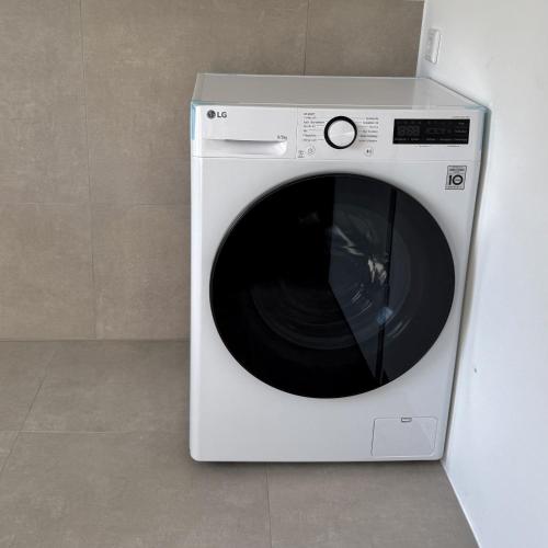 a white washing machine sitting in a room at Apartmenthaus Gilden 1 in Borken