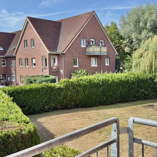 a house with a hedge in front of it at Apartmenthaus Gilden 1 in Borken