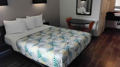 a hotel room with a bed and a table at Motel 6-Watsonville, CA - Monterey Area in Watsonville