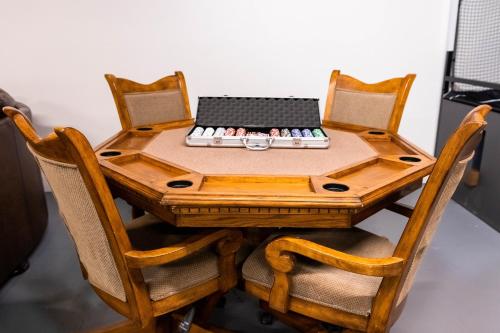 a wooden table with two chairs and a laptop on it at The Lookout At Lakewood, By M Host in Bridgeport