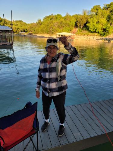 a woman standing on a dock holding a rope at The Lookout At Lakewood, By M Host in Bridgeport