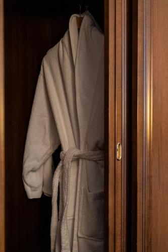 a robe is hanging on a closet door at Hotel International in Sinaia