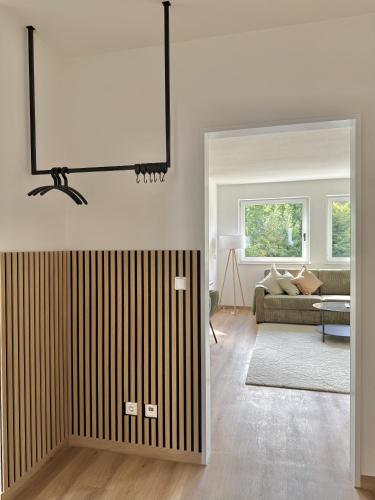 a living room with a couch and a large mirror at Apartmenthaus Gilden 1 in Borken