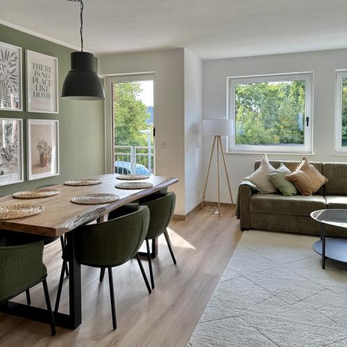 a living room with a table and a couch at Apartmenthaus Gilden 1 in Borken