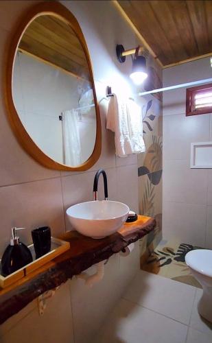 a bathroom with a sink and a mirror at Casa Josuá in Nísia Floresta