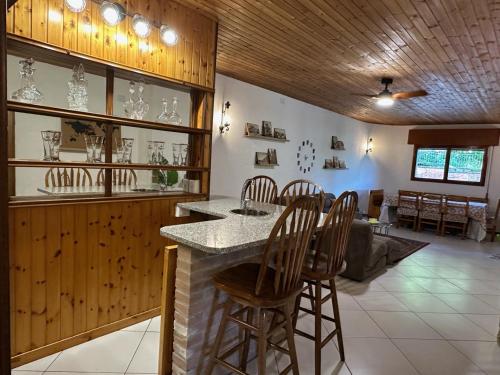 a kitchen with a bar with chairs and a table at Peaceful Country Living at Apartments at Villa Clara in Vimignano