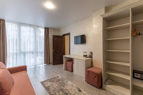 a living room with a bed and a desk at Gold Palace SPA Resort Bukovel in Bukovel